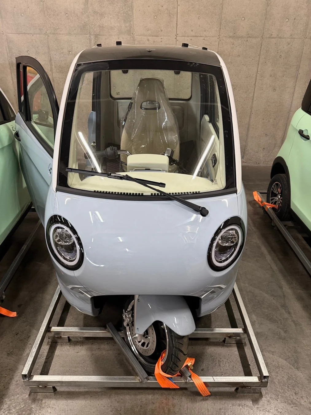 水色の三輪マイクロカー、輸送中