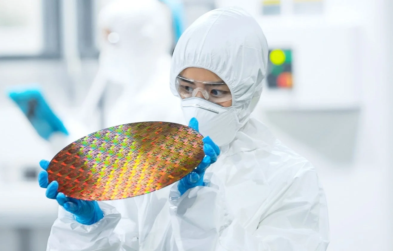 クリーンルームで半導体ウェハーを検査する技術者
